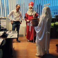 Mikulášska návšteva v kancelárii EVPÚ a.s. – Mikuláš s anjelom obdarúva zamestnancov